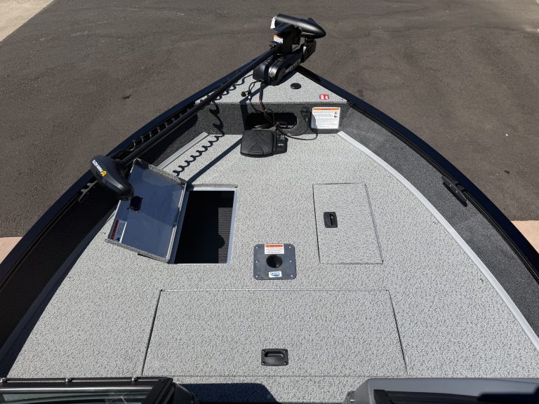 Boat deck with electronics and storage compartments for fishing or leisure.