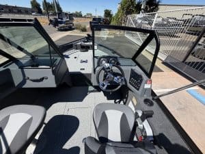 Boat cockpit with steering wheel and controls, new website branding.