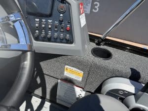 Close-up of boat control panel with switches and gauges for marine navigation.