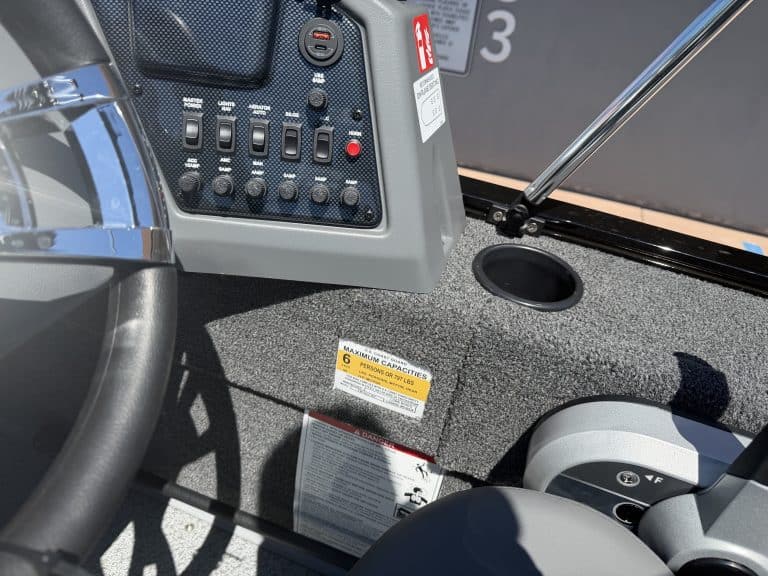 Close-up of boat control panel with switches and gauges for marine navigation.