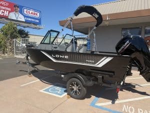 Lowe FM 1625 WT boat with Mercury 90HP outboard motor in parking lot.