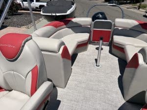 Comfortable pontoon boat seating with red and white upholstery.