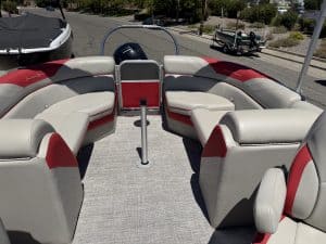 Interior view of a South Bay LE 22FT pontoon boat with white and red seating.