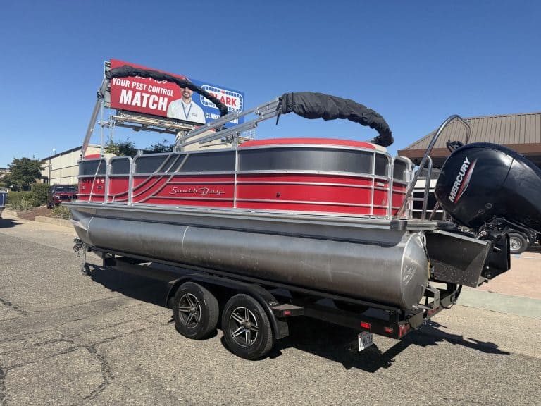 Red and gray South Bay LE 22FT pontoon boat with Mercury outboard motor on trailer.