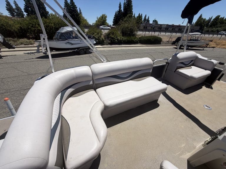 Comfortable boat seating with white cushioned benches and safety railings.