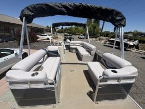 Luxury pontoon boat with seating and canopy for leisure and fishing.