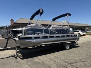 Pontoon boat with Bimini tops on a trailer at ASFB Marine.