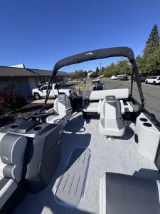 Bennington 22FT SwingBack pontoon boat with Mercury 200HP engine on display.