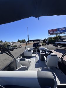 View of the interior of a Bennington 22FT SwingBack boat with seating and steering console.