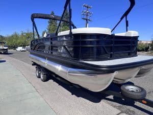 Bennington 22FT SwingBack pontoon boat with Mercury 200HP engine on trailer.