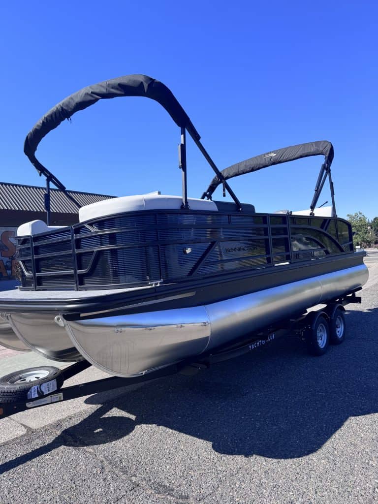 Bennington 22FT SwingBack pontoon boat with Mercury 200HP engine on trailer.