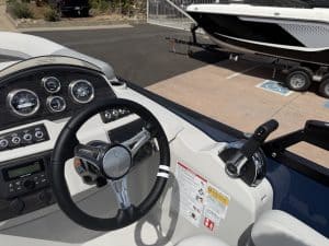 Boat dashboard with steering wheel and controls for Lowe SS 230 WV.
