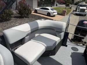 Comfortable boat seating area with white cushions on a pontoon boat.