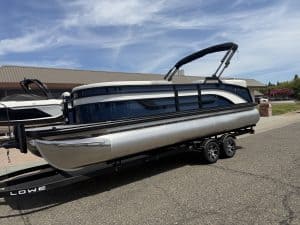 Lowe SS 230 WV pontoon boat with Mercury 150HP engine on trailer.