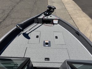 Boat deck with trolling motor and storage compartments.