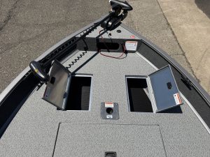 Fishing boat deck with storage compartments and trolling motor.