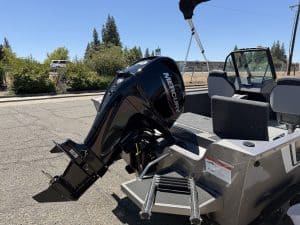 Lowe FM 1625 WT boat with Mercury 60HP outboard motor in parking lot.