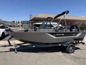 Lowe FM 1625 WT boat on trailer with outboard motor and canopy.