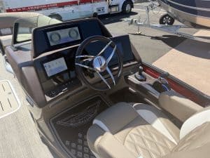 Close-up of the Bennington 25FT Q boat dashboard and steering wheel.