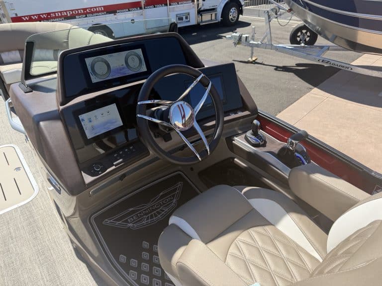 Close-up of the Bennington 25FT Q boat dashboard and steering wheel.