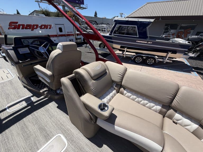 Luxury pontoon boat interior with seating and steering console at ASFB Marine.