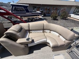 Luxury Bennington 25FT Q pontoon boat with seating and steering console.