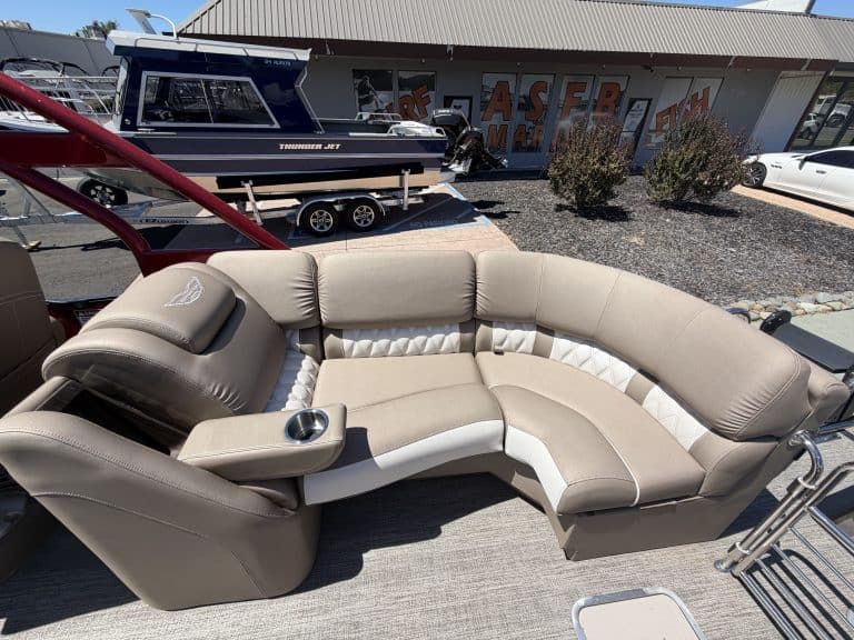 Luxury Bennington 25FT Q pontoon boat with seating and steering console.