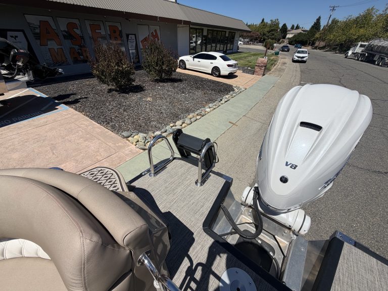 View of ASFB Marine dealership with boats and vehicles outside.