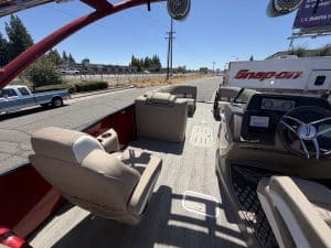 View of Bennington pontoon boat cockpit with steering and seating.