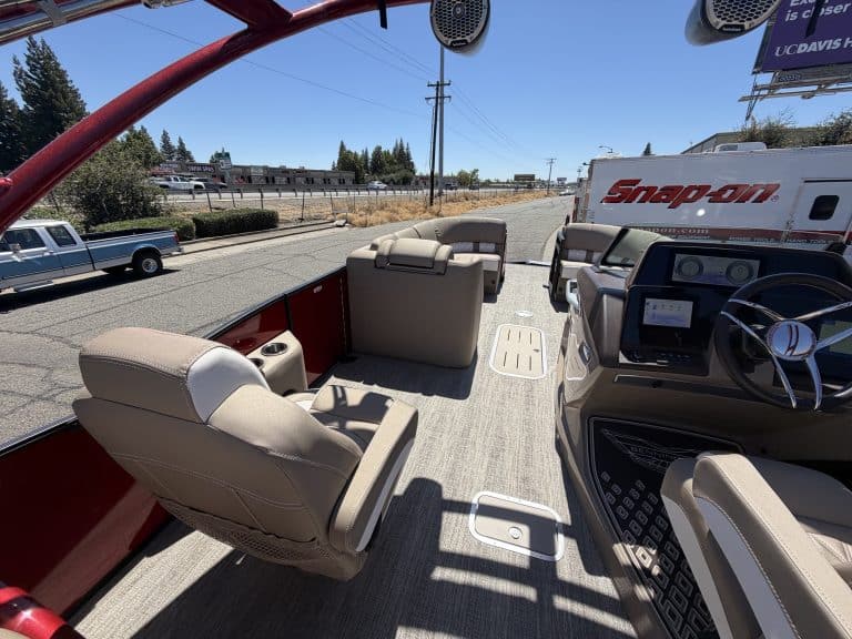 View of Bennington pontoon boat cockpit with steering and seating.