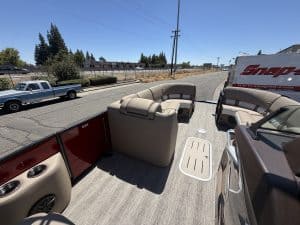 View of boat interior with seating and flooring for the Bennington 25FT Q.
