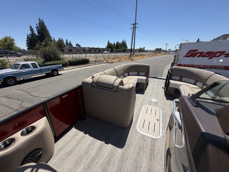 View of boat interior with seating and flooring for the Bennington 25FT Q.