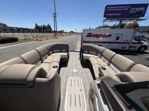 Luxury Bennington 25FT Q pontoon boat with beige seating.