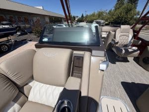 Luxury boat interior with beige and cream seating and dashboard.