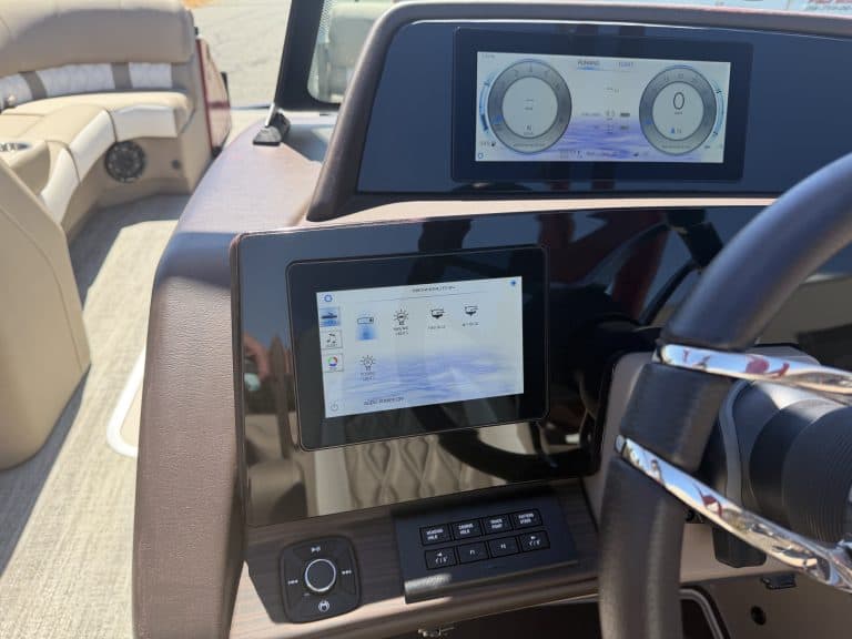 Close-up of boat dashboard with digital controls and displays.