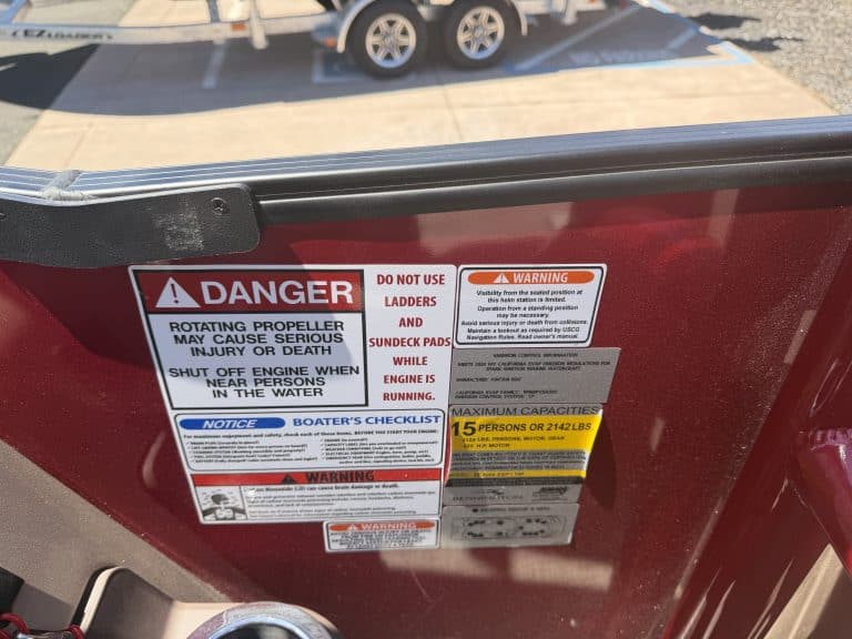 Boat safety and warning labels on a Bennington 25FT Q boat.