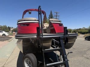 Red and black Bennington 25FT Q pontoon boat with ladder and seating.