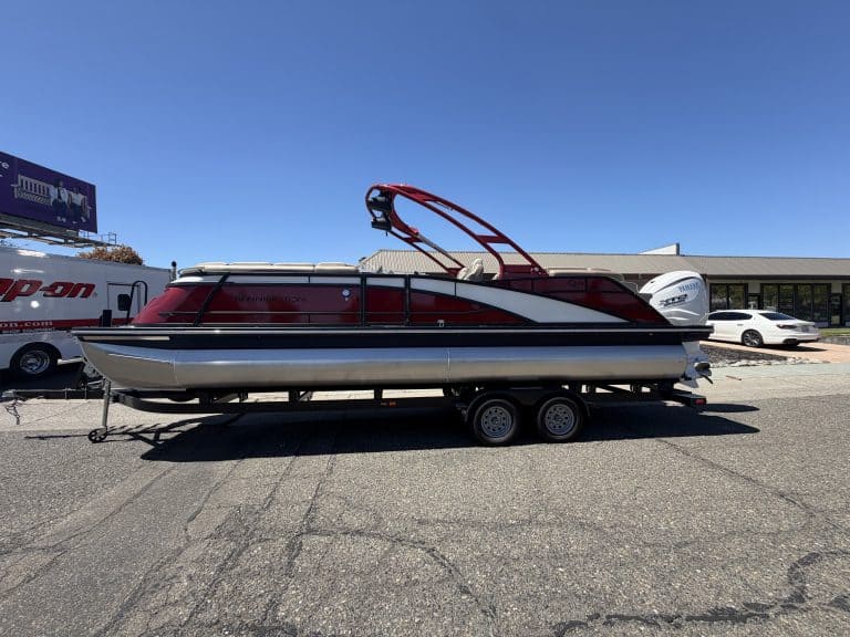 Bennington 25FT Q pontoon boat with 450HP engine on trailer.