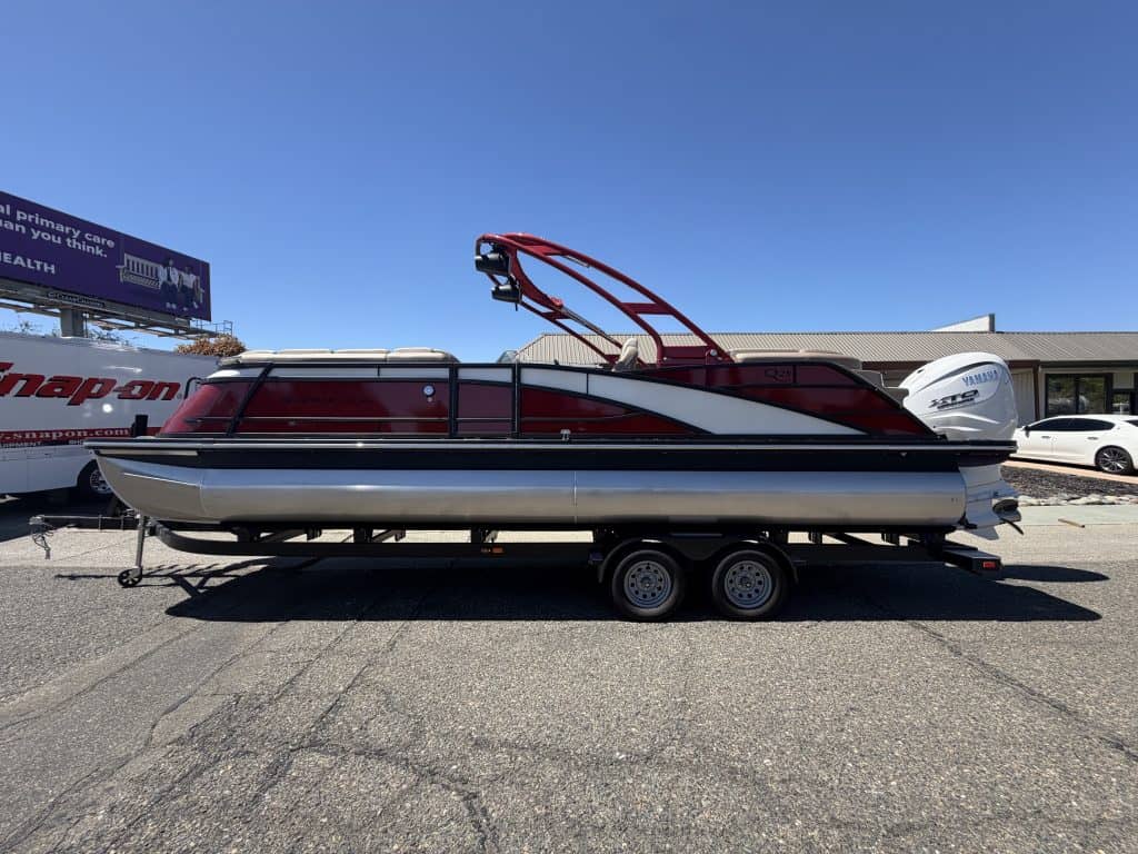 Bennington 25FT Q pontoon boat with 450HP engine on trailer.