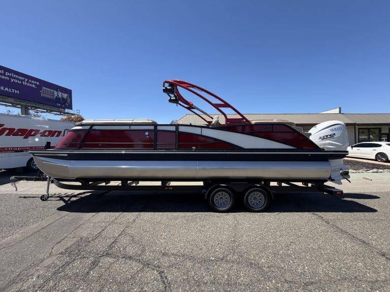 Bennington 25FT Q pontoon boat with 450HP engine on trailer.