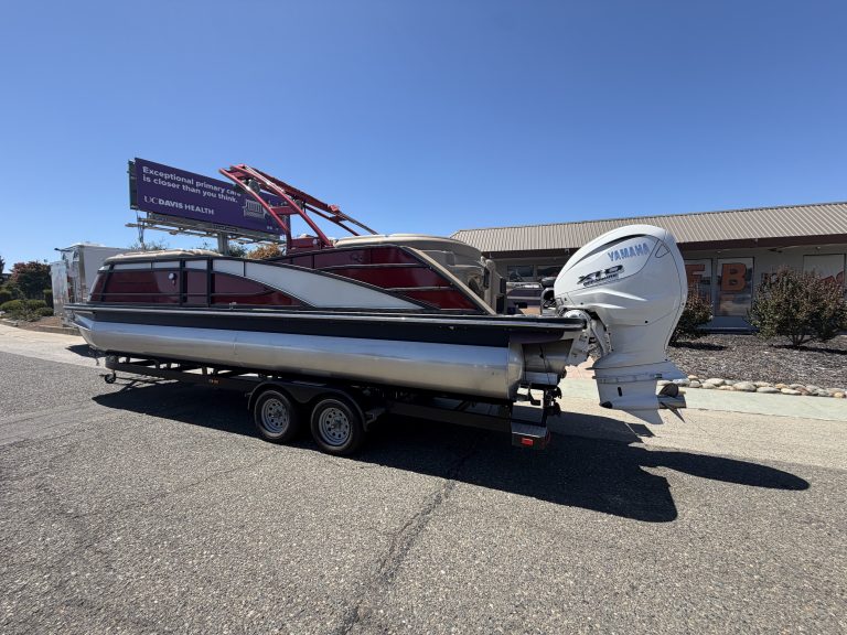 Bennington 25FT Q pontoon boat with Yamaha engine on trailer.