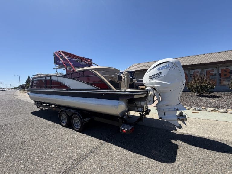 Bennington 25FT Q pontoon boat with Yamaha outboard engine on trailer.