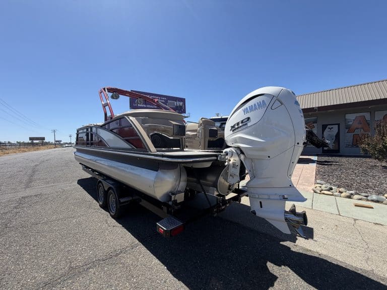 Bennington 25FT Q pontoon boat with Yamaha engine on trailer.