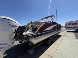 Bennington 25FT Q pontoon boat with 450HP engine on trailer.