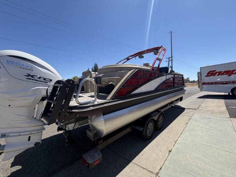 Bennington 25FT Q pontoon boat with 450HP engine on trailer.