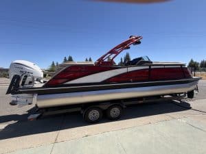 Bennington 25FT Q pontoon boat with 450HP engine on trailer.