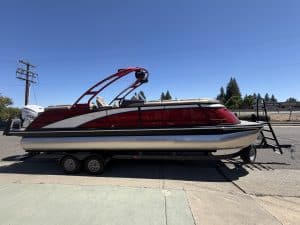 Bennington 25FT Q pontoon boat with 450HP engine on trailer.