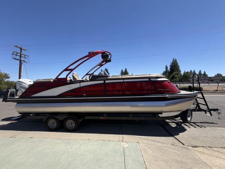 Bennington 25FT Q pontoon boat with 450HP engine on trailer.