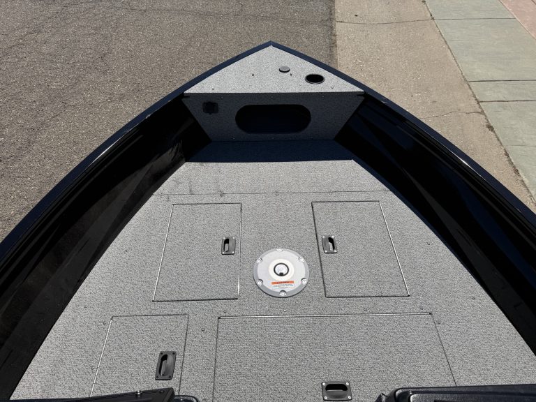 Close-up of boat deck with storage compartments and mounting points.