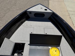 Fishing boat interior with storage and live well for anglers.